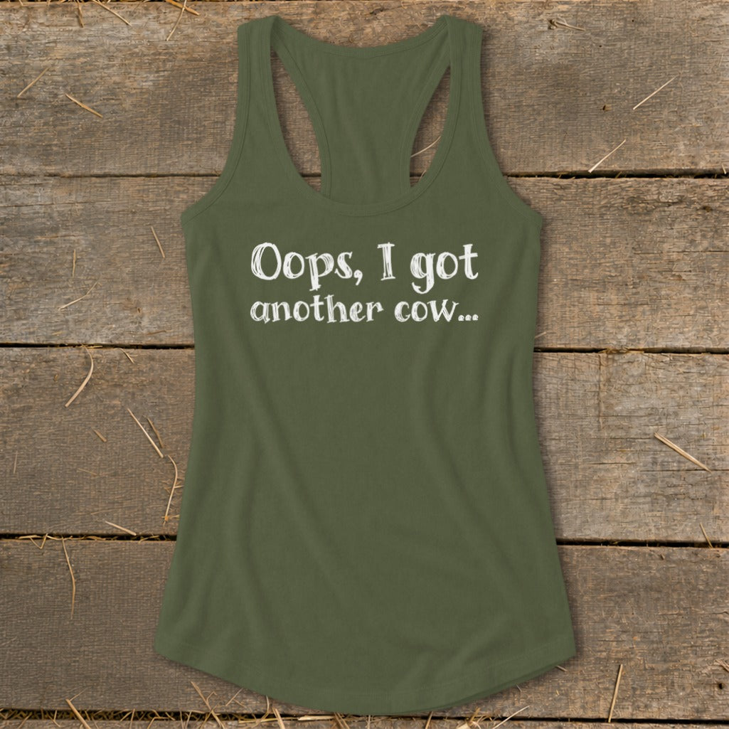 Olive green tank top with white text reading "Oops, I got another cow...".