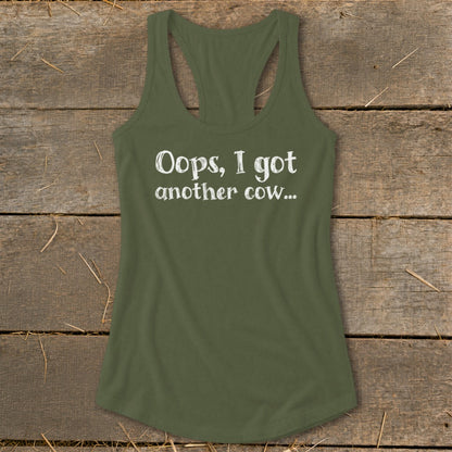 Olive green tank top with white text reading "Oops, I got another cow...".