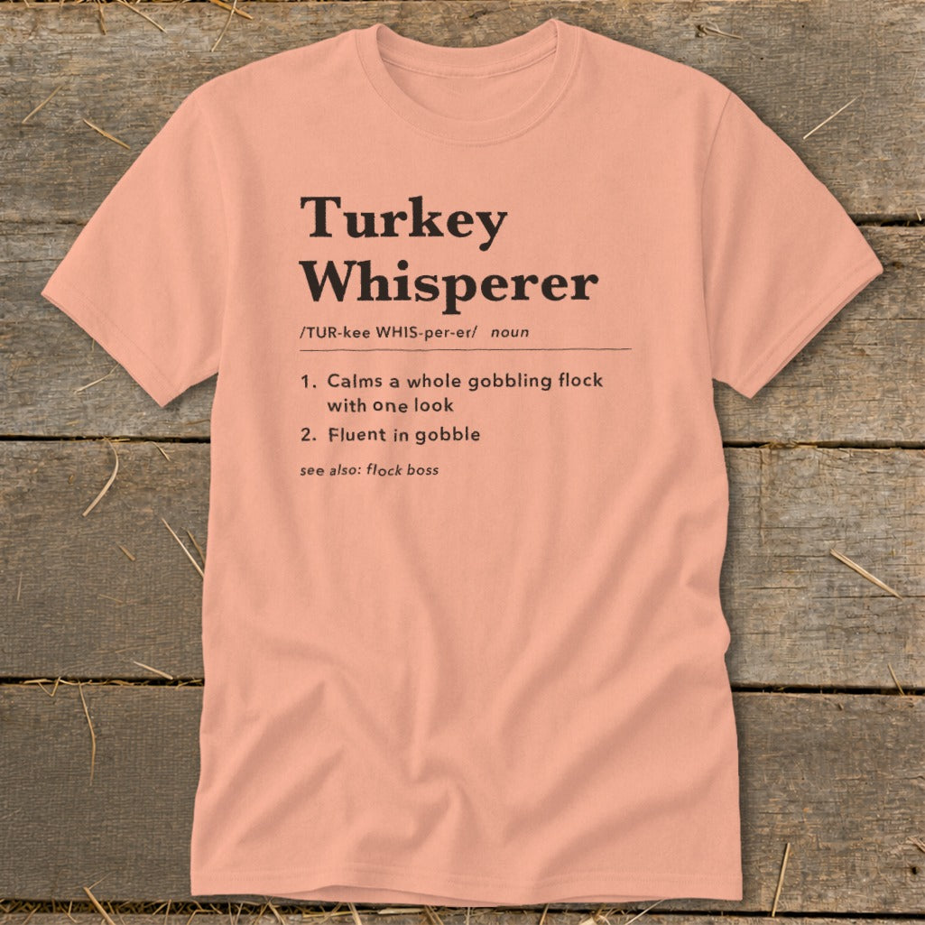 Peach t-shirt with "Turkey Whisperer" definition and humorous text.