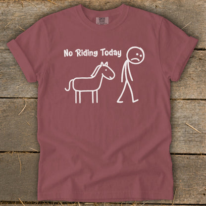 Maroon t-shirt with white text "No Riding Today" and stick figures of a horse and a sad person.