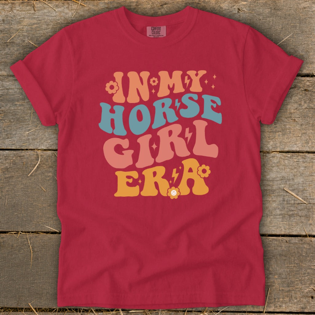 "In My Horse Girl Era" graphic tee in berry red with retro text.