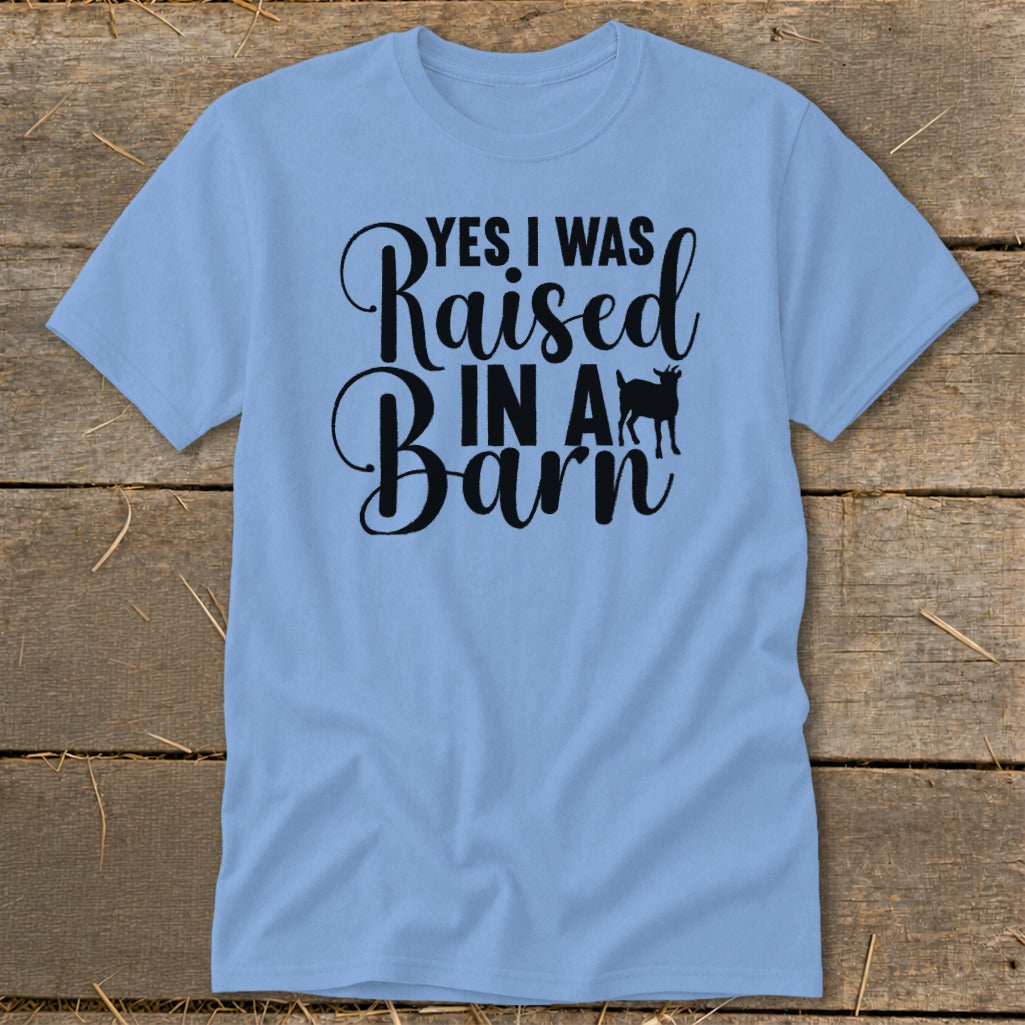 Light blue t-shirt with black text "YES I WAS Raised IN A Barn" and goat silhouette.