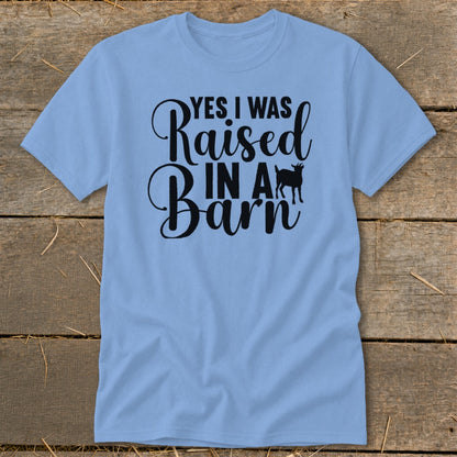 Light blue t-shirt with black text "YES I WAS Raised IN A Barn" and goat silhouette.