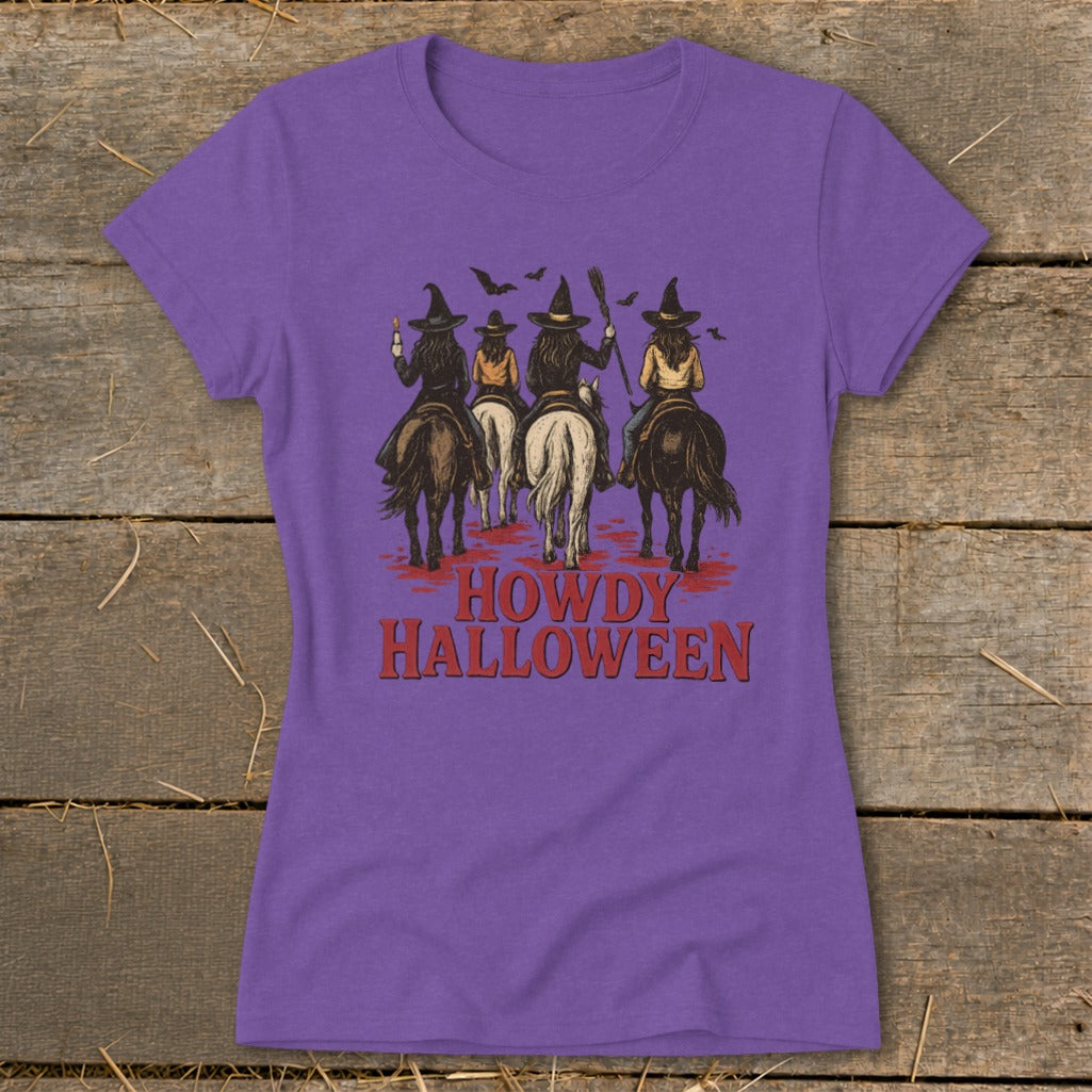 Purple t-shirt with "Howdy Halloween" text and four witches riding horses.