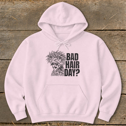Pink hoodie with a black graphic of a fancy chicken and text reading "BAD HAIR DAY?".