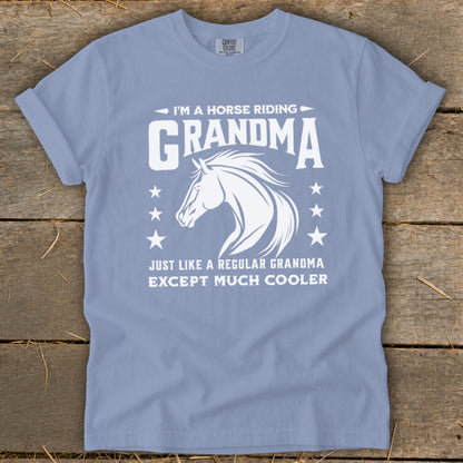 Light blue t-shirt with white text and horse graphic: "I'm a horse riding Grandma. Just like a regular Grandma except much cooler."