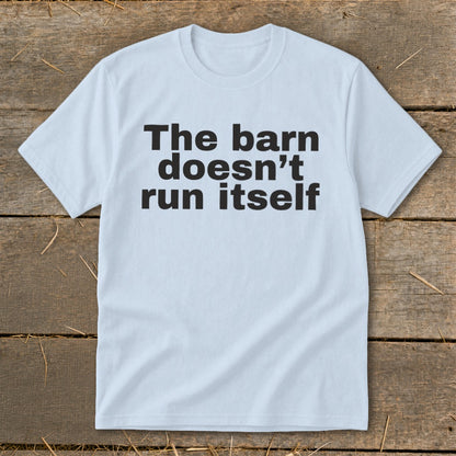 Light blue t-shirt with black text reading "The barn doesn't run itself".