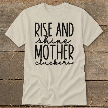 Light-colored t-shirt with "Rise and shine mother cluckers" text.