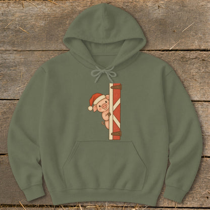 Olive green hoodie with a pig wearing a Santa hat peeking from a red barn door.