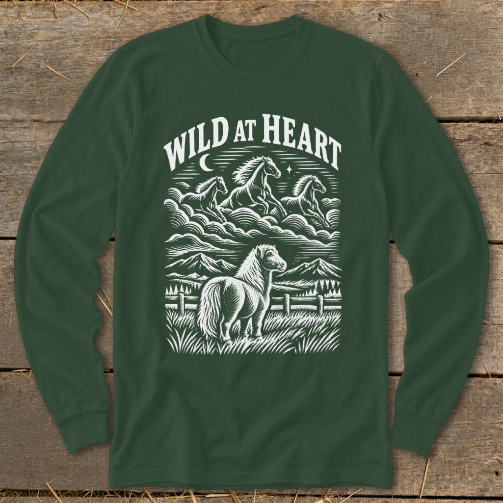 Dark green long-sleeve t-shirt with a white graphic print of running horses and mountains, reading WILD AT HEART.