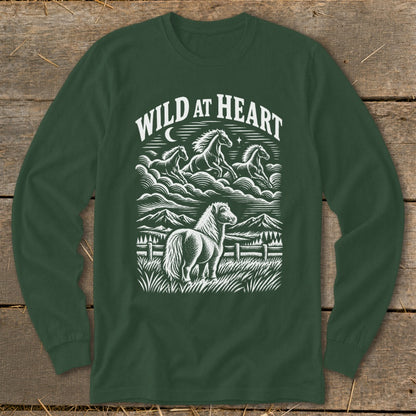 Dark green long-sleeve t-shirt with a white graphic print of running horses and mountains, reading WILD AT HEART.