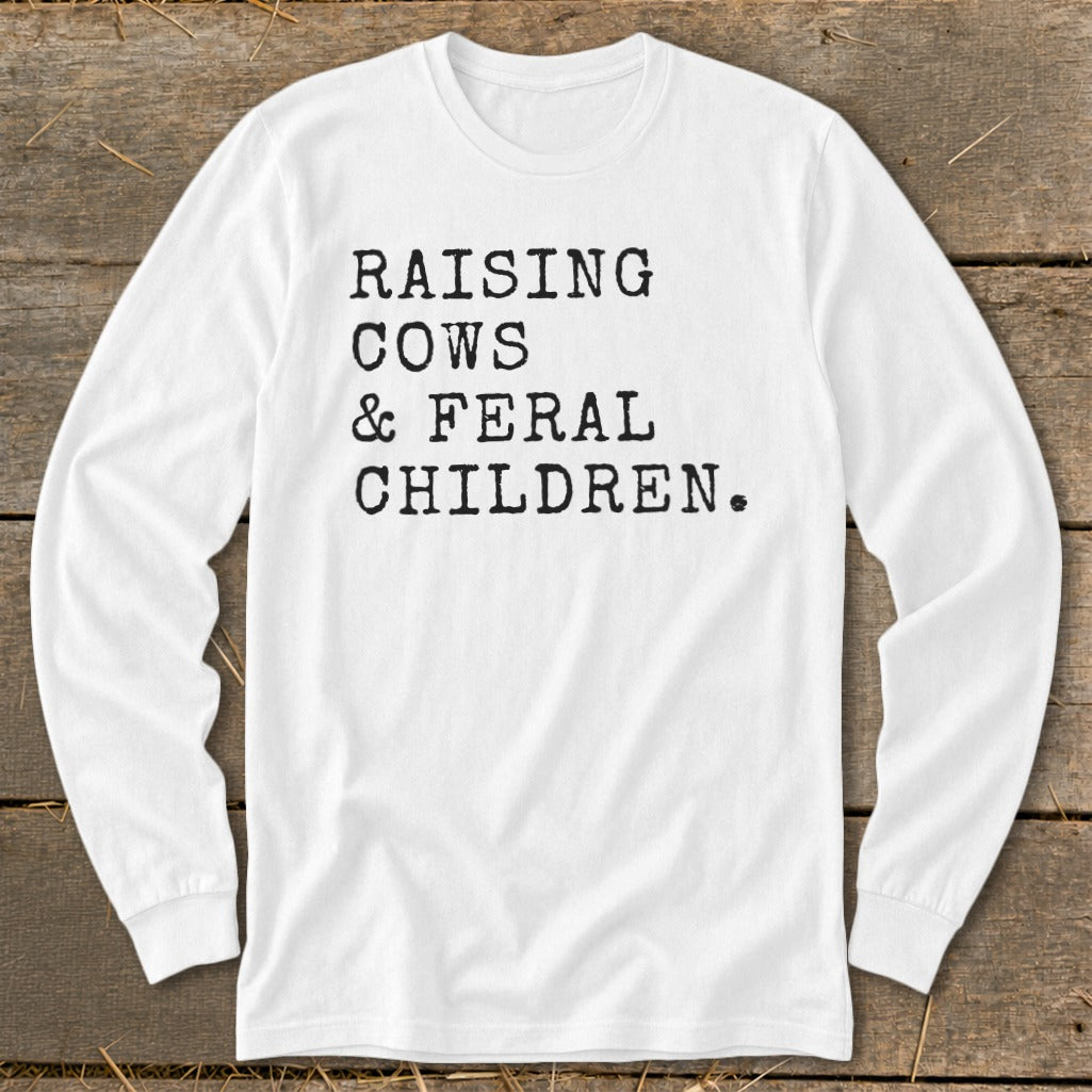 White long-sleeve shirt with black text "RAISING COWS & FERAL CHILDREN."