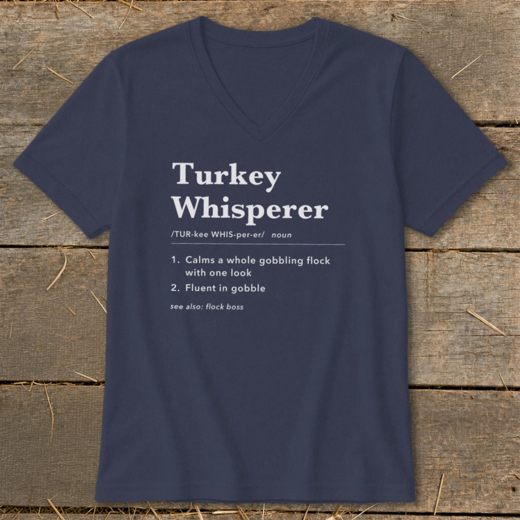 Navy t-shirt with "Turkey Whisperer" definition: Calms gobbling flock, fluent in gobble.
