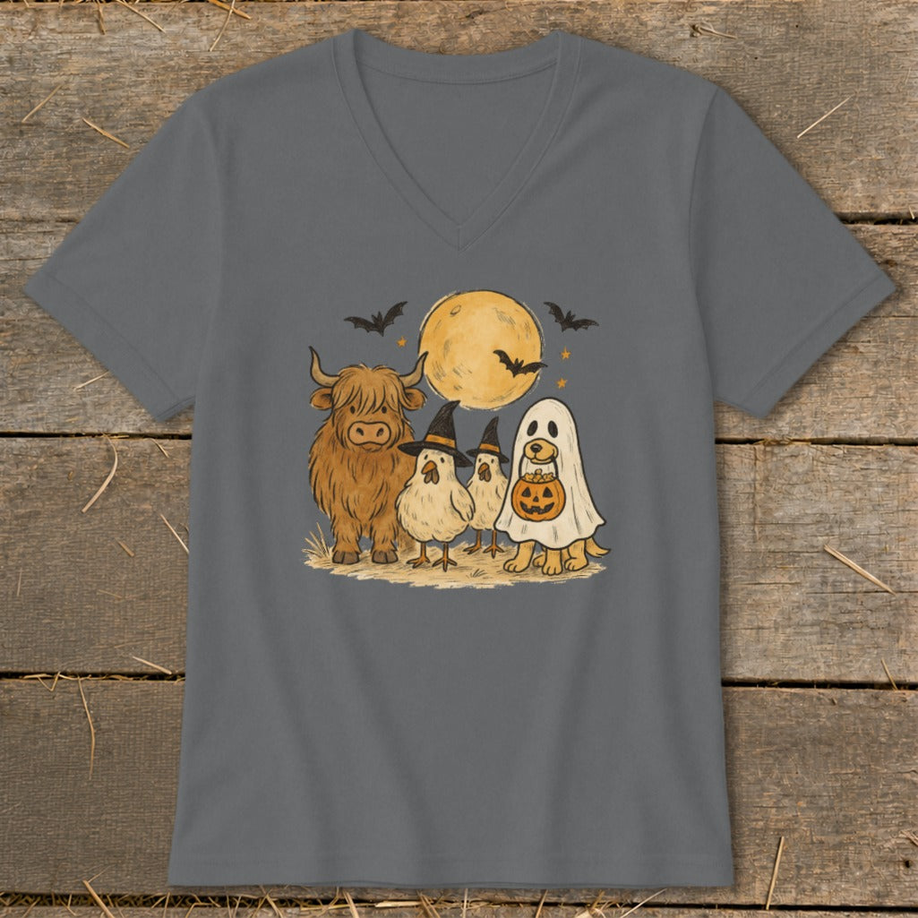 Highland cow, chickens, and dog in ghost costume on Halloween night.