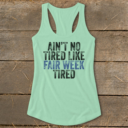 Mint green tank top with "Ain't No Tired Like Fair Week Tired" text.