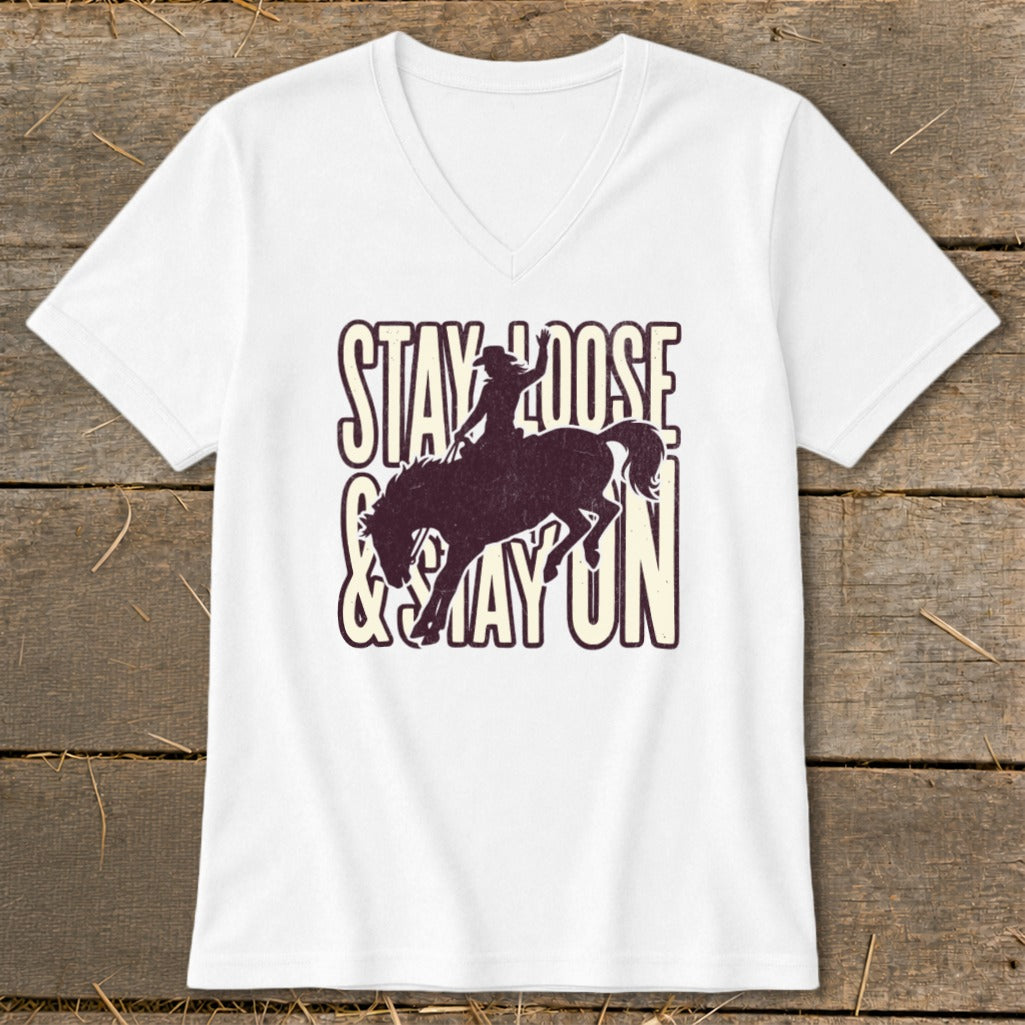 White v-neck shirt with distressed "Stay Loose & Stay On" text and bucking bronco rider.