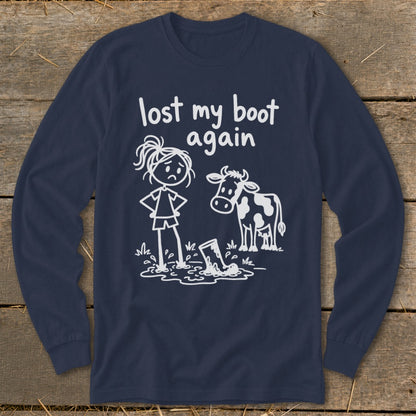 Navy blue long-sleeve t-shirt with a white graphic of a sad girl and cow looking at a muddy boot, and text reading lost my boot again.