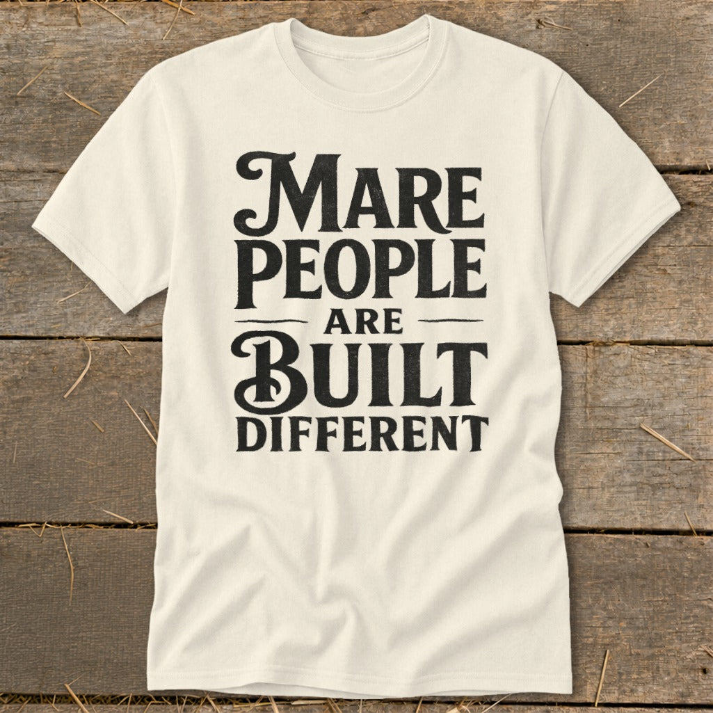 Cream t-shirt with black text reading "Mare people are built different."