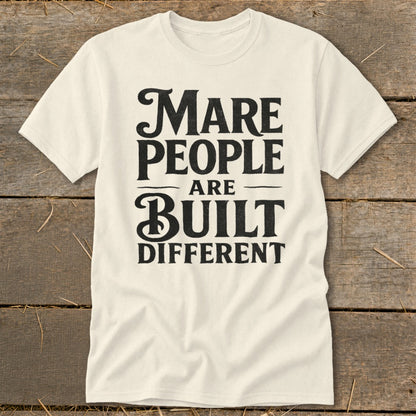 Cream t-shirt with black text reading "Mare people are built different."
