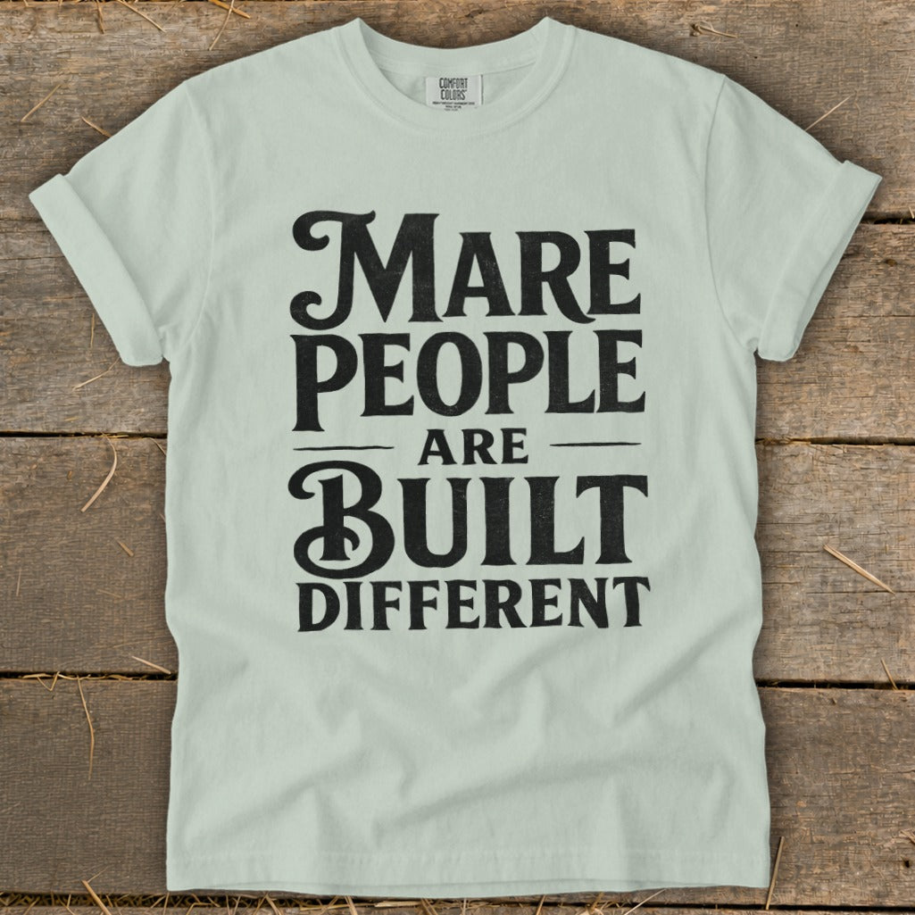 Light green t-shirt with black text "Mare People Are Built Different".
