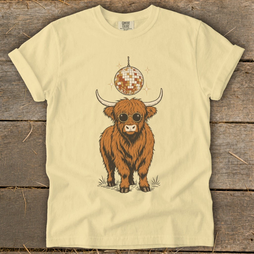 Highland cow wearing sunglasses under a disco ball.