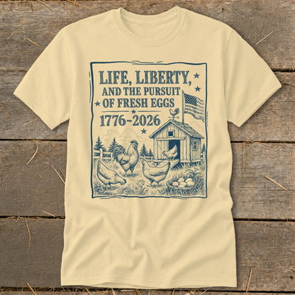 Cream t-shirt with "Life, Liberty, and the Pursuit of Fresh Eggs" text and chicken farm illustration.