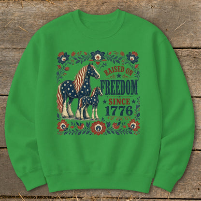 Green sweatshirt with horses and the text "Raised on Freedom Since 1776".