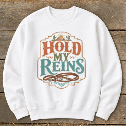 White sweatshirt with "Hold My Reins" text and horse reins graphic.
