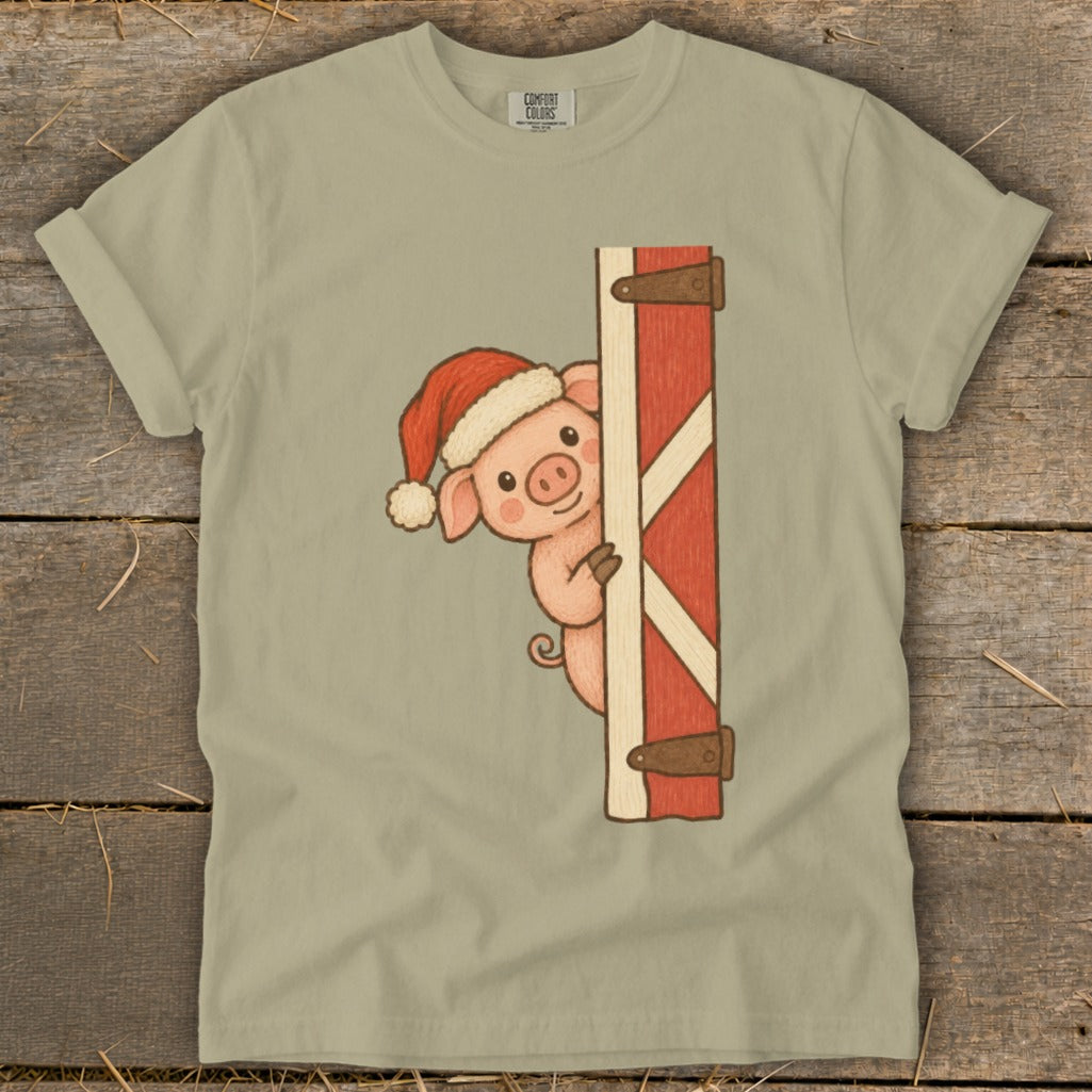 Pig wearing Santa hat peeking around barn door.