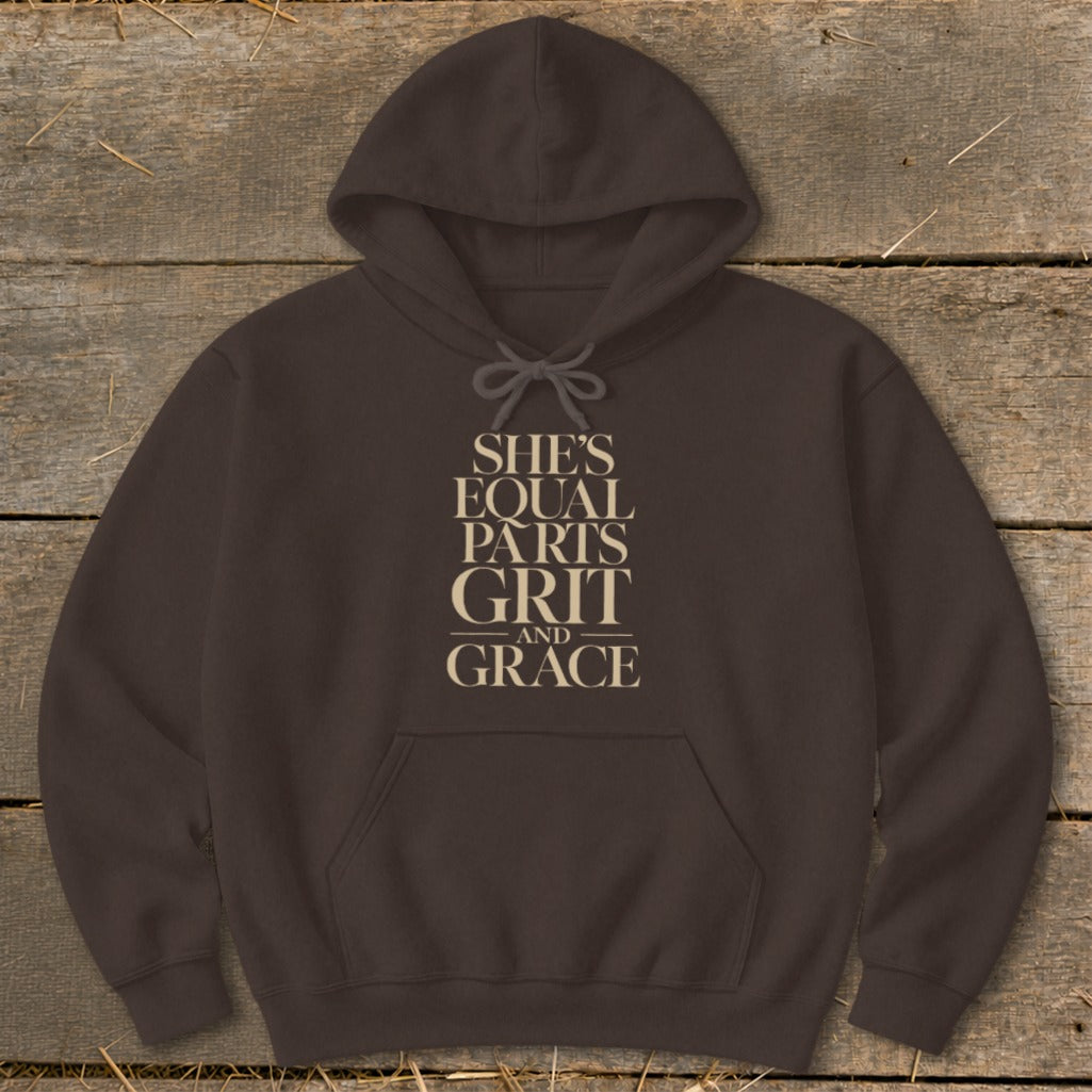 Brown hoodie with "SHE'S EQUAL PARTS GRIT AND GRACE" text on chest.