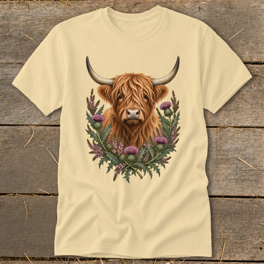 Cream t-shirt with Highland cow and thistles graphic.