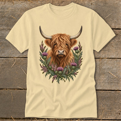 Cream t-shirt with Highland cow and thistles graphic.