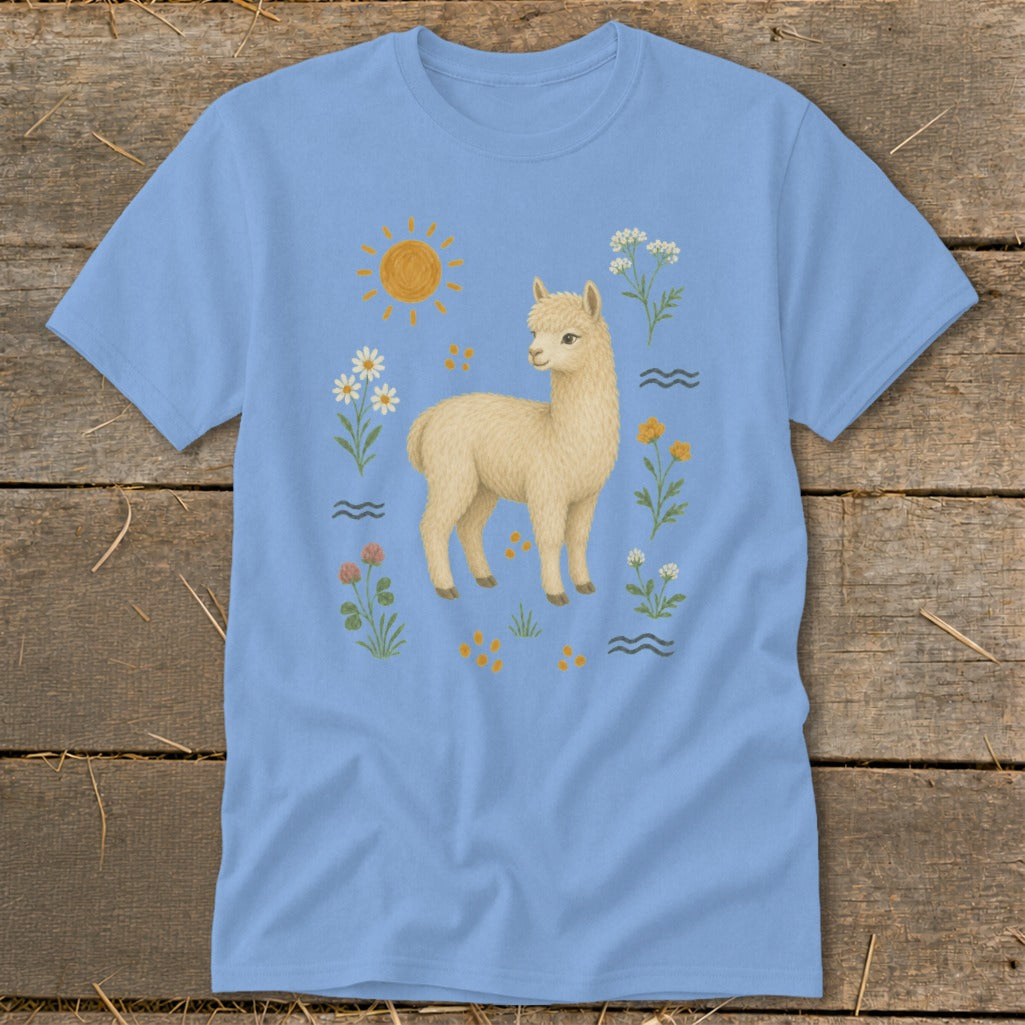 Light blue t-shirt with a cream alpaca and whimsical floral, sun, and wave designs.