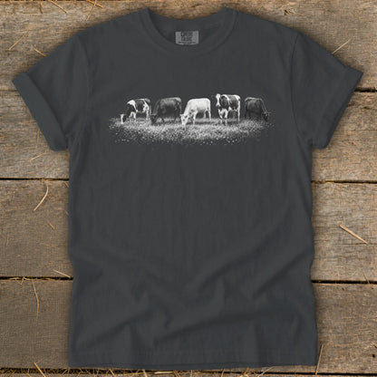 Dark gray t-shirt with five cows grazing in a field.