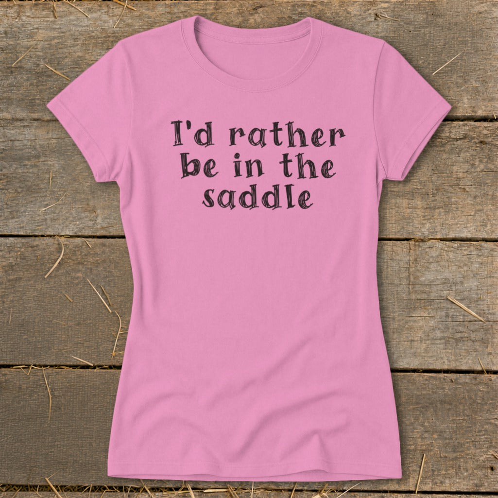 Pink t-shirt with "I'd rather be in the saddle" printed in black.