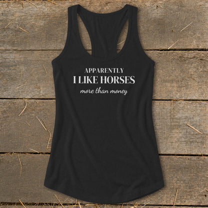 Black racerback tank top with white text: "APPARENTLY I LIKE HORSES more than money".