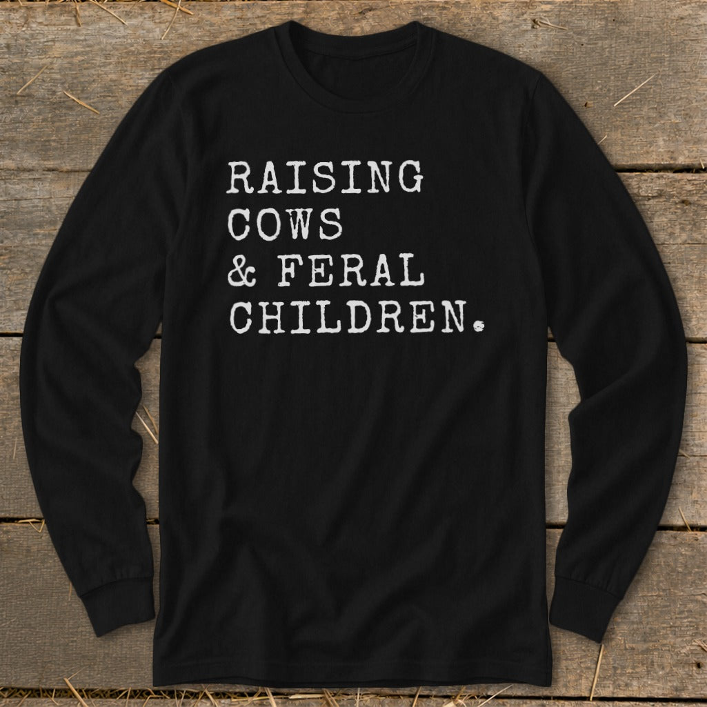 Black long sleeve shirt with white text "RAISING COWS & FERAL CHILDREN."