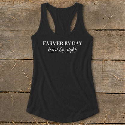 Black racerback tank top with "FARMER BY DAY tired by night" text.