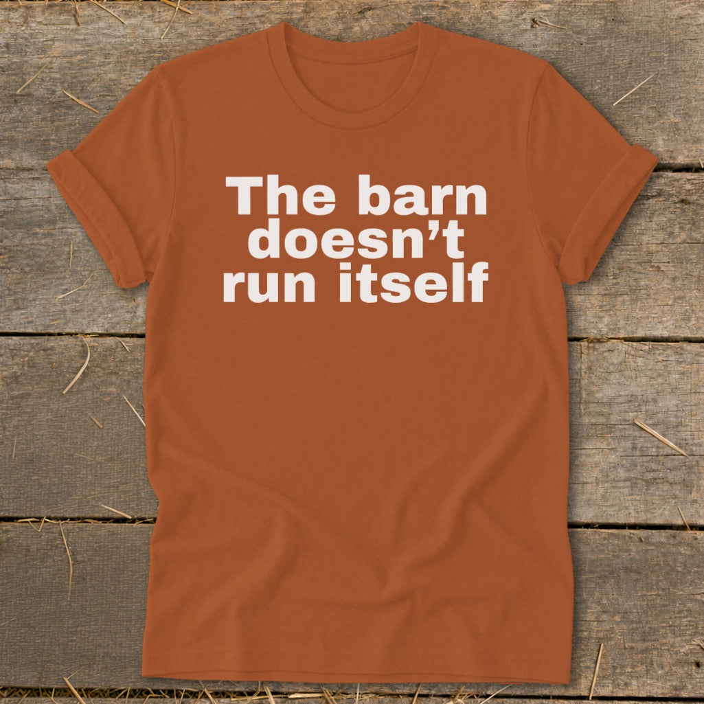 Orange t-shirt with white text that reads "The barn doesn't run itself".