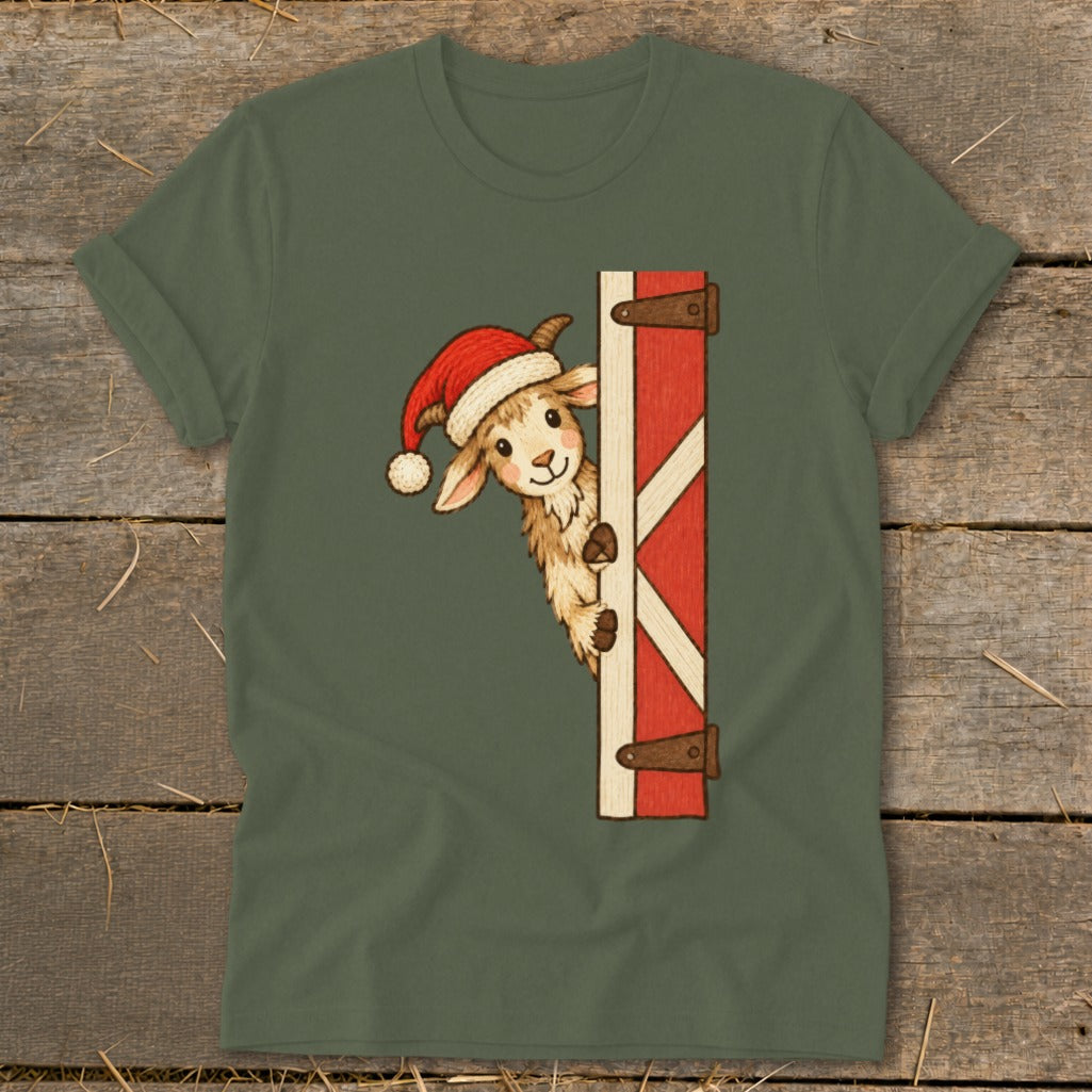 Cute goat wearing Santa hat peeking around a red barn door.