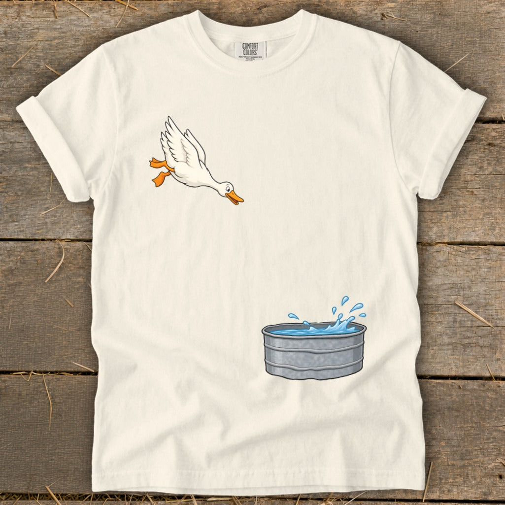 White t-shirt with cartoon of a duck jumping into a galvanized tub of water.