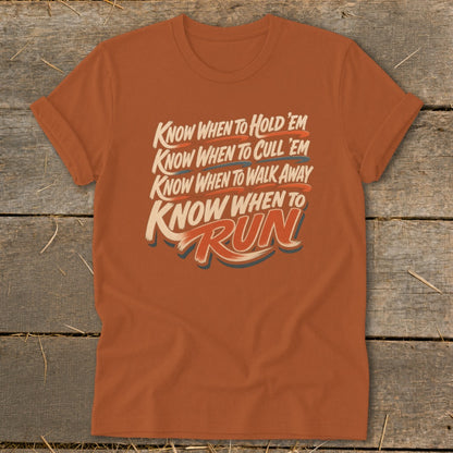 Orange t-shirt with text "Know When To Hold 'Em, Cull 'Em, Walk Away, Run".
