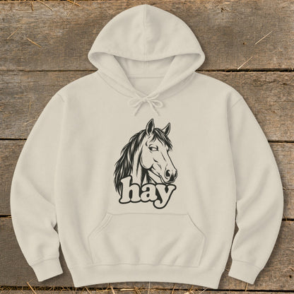 Cream hoodie with black horse head graphic and "hay" text.