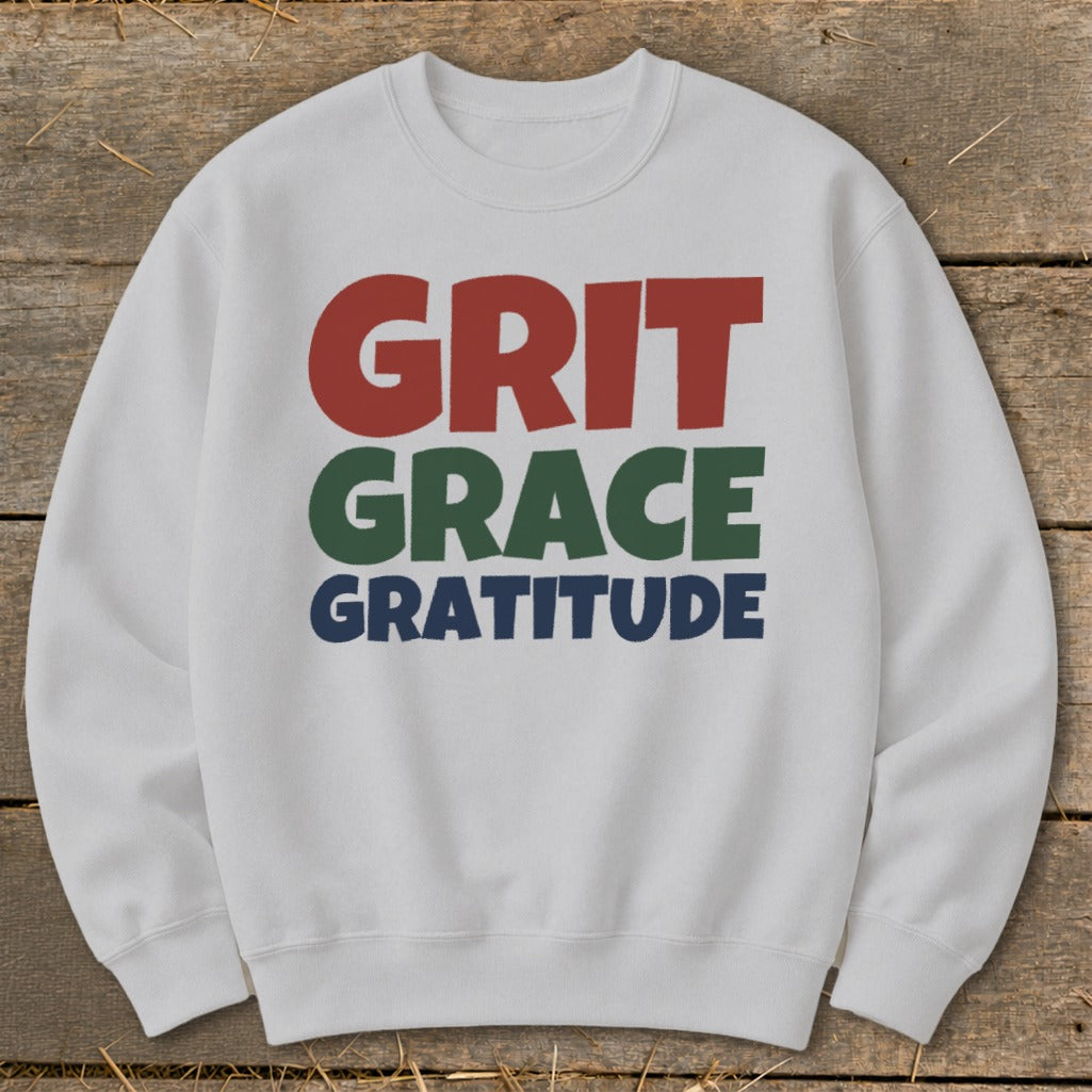 Light gray crewneck sweatshirt featuring the words GRIT in red, GRACE in green, and GRATITUDE in blue.