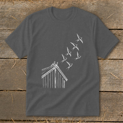 A dark gray crewneck t-shirt featuring a white line drawing of a barn with birds flying from its roof.