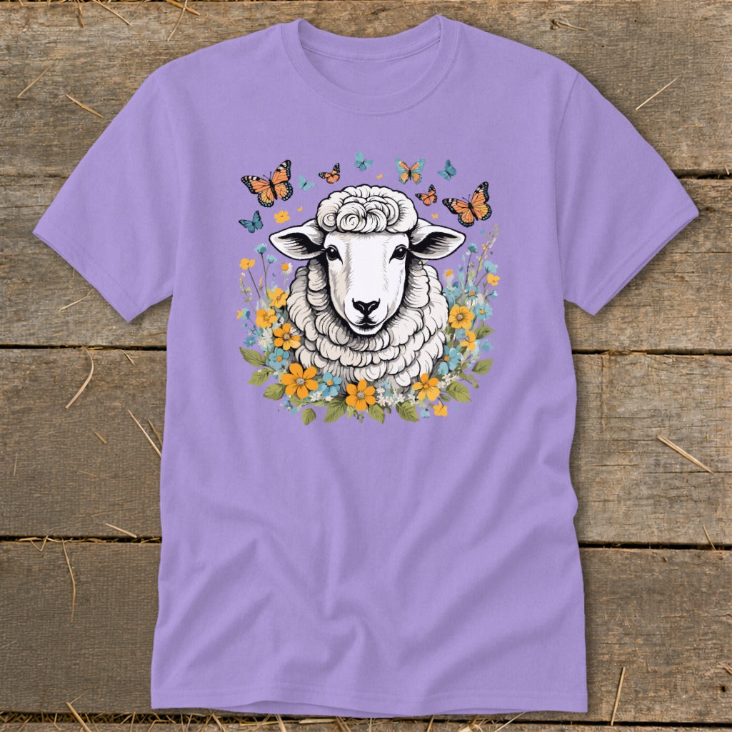 Purple t-shirt with a fluffy sheep surrounded by colorful flowers and butterflies.