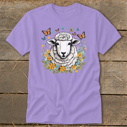 Purple t-shirt with a fluffy sheep surrounded by colorful flowers and butterflies.