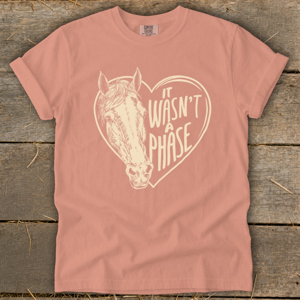 Peach t-shirt with cream graphic of a horse's head inside a heart, reading "It Wasn't A Phase."