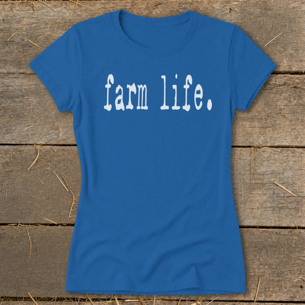 Blue t-shirt with white text "farm life." on a wooden background.