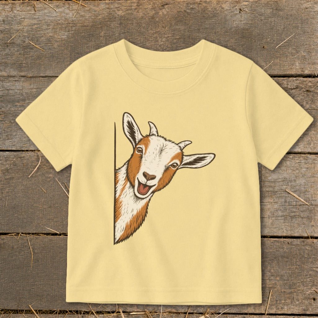 Yellow t-shirt with a cartoon illustration of a happy goat peeking from the side.